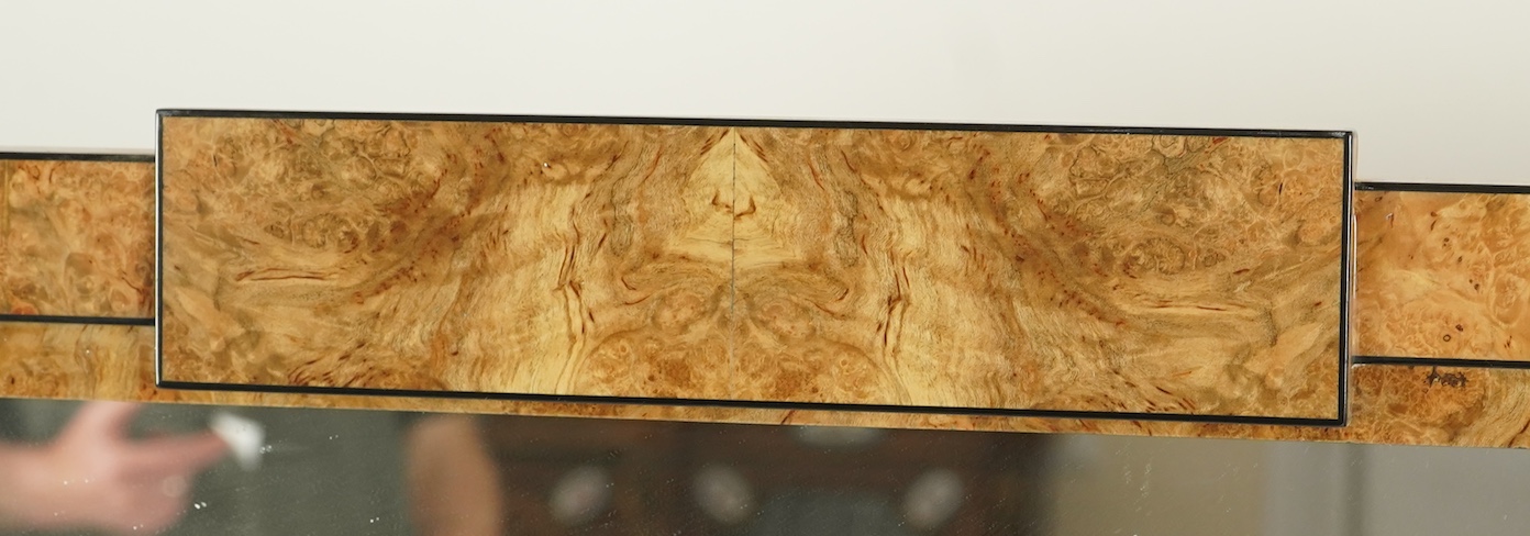 An Art Deco style sweetgum veneered rectangular overmantel mirror